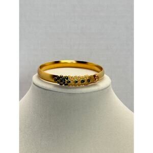 Goldtone unsigned bangle with peacock